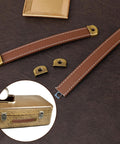Leather Drawer Pulls Set Of 2 With Mounting Screws Brown PU Leather Trunk Handles And Cabinet Pulls displayed against leather surface