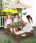 Children seated at Kid Approved Outdoor Picnic Table Set With Cushioned Benches, Adjustable Height Table, Built In Umbrella, Coffee Finish.