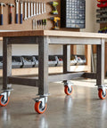 4pcs Inch TPR Swivel Caster Wheels with Brake, M8 Post mounted on a sturdy workbench in a garage setting