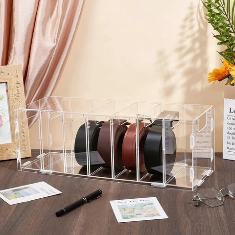 Top Shelf Slick Acrylic Belt Organizer With Removable Dust Cover Seven Compartment Clear Drawer Storage for Ties Belts Bow Tie Purse Socks with belts displayed.