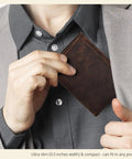 Man placing Mens Trifold Leather Wallet With RFID Blocking Slim Minimalist Front Pocket Dope Look Real Leather into pocket