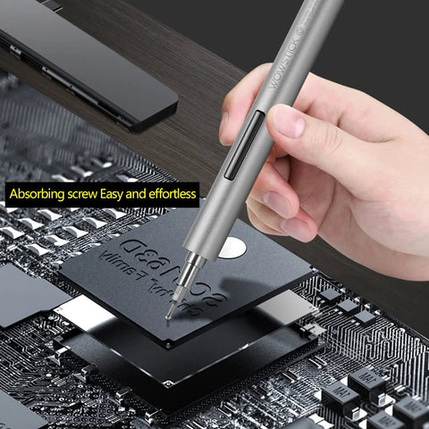 Hand holding Tiny But Mighty Mini Electric Screwdriver Kit 69 In 1 Cordless Precision Tool on circuit board