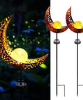 2 Pack Solar Moon Lights With Crackle Glass Globes In Antique Brass Finish On Durable Metal Stakes glowing in garden