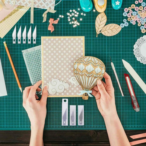 Hands using Go To Craft Knife Kit With Self Healing Cutting Mat And 30 SK-5 Blades for precise crafting in art and DIY projects.
