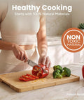Woman slicing red bell pepper on Heavy Duty 3 Piece Bamboo Cutting Board Set With Wooden Stand For Everyday Kitchen Tasks.