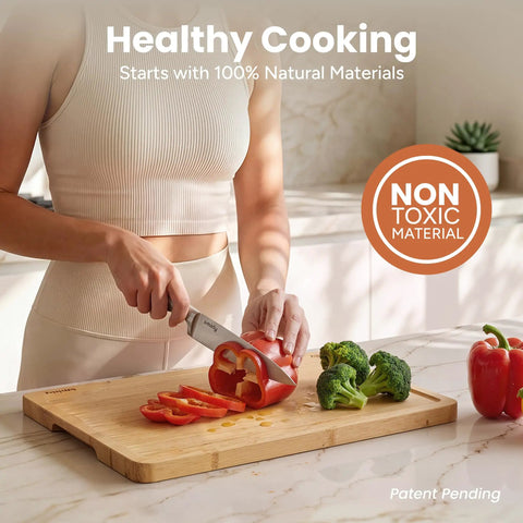 Woman slicing red bell pepper on Heavy Duty 3 Piece Bamboo Cutting Board Set With Wooden Stand For Everyday Kitchen Tasks.
