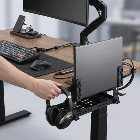 Adjustable Under Desk Laptop Holder With Integrated Cord Organizer Rack Quick Grip Edge Clamp holding a laptop and headphones