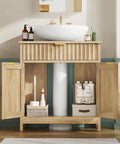 Kick Up Your Bathroom Style With This Slick Fluted Pedestal Sink Cabinet Featuring Two Doors And A Bottom Drawer In Natural Oak U Shape Cutout For Dope Space Saving Vibes with storage inside.
