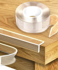 Rock Solid Clear Corner Protectors For Baby Proofing Hella Tough Soft Edge Guards with clear adhesive tape on wooden table edge.