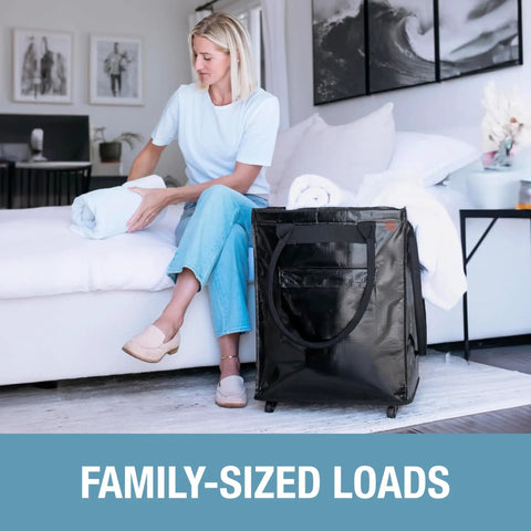 Woman sitting next to 90L Collapsible Rolling Tote With Wheels For Groceries And Laundry, Built Tough Heavy Duty Utility Cart in black.