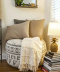 Coastal Pineapple Table Lamp With Linen Shade And Distressed Finish for living room, beside round ottoman and pillows, brings dope beach vibe