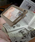 Person using Bronze Floor Magnifier Lamp With 8x10 Inch Shade 3x Magnification Built In LED Lighting Full Page View for reading