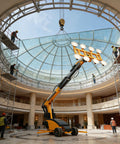 Electric Glass Suction Lifter With Wireless Remote And 360 Degree Spin For Moving Massive Sheet Panes Without Breaking A Sweat On Demanding Construction Sites in action lifting a glass dome.
