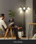 Five Head LED Floor Lamp With Dimmable 4000 Lumens, Tall Adjustable Standing Light illuminating a man reading in a living room