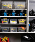 Organized shelving with labeled bins holding dimmers, clamps, ropes, and safety cables using Knockout Performance P Touch Pro Label Maker.