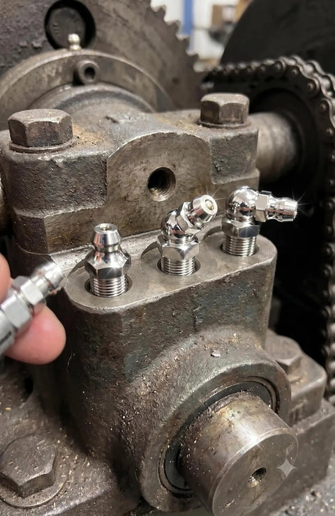Grab This 12-Pack Of Pro Grade 1/4 Inch 28 Unf Stainless Zerk Grease Nipples For Your American Ride With A Leak Free Seal That Keeps Your Chassis Smooth And Fully Lubed For The Long Haul. 1/4-28 stainless grease fittings installed in a chassis block