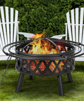 36 Inch Wood Burning Fire Pit with Spark Screen and Fire Poker in yard, featuring durable steel cross weave design built for bonfires.