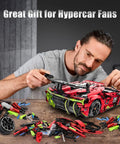Man assembling Remote Control Hypercar Building Kit With Five Fast Motors, 1835-Piece Set, visible parts and instructions.
