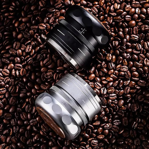 Top Shelf 4 Piece Espresso Kit Featuring Adjustable Height Spring Coffee Tamper For 58mm Portafilter with two coffee tampers on coffee beans.