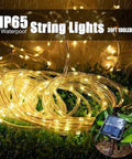 Solar Rope Light IP65 Waterproof 39Ft 100LEDs Outdoor String Lights on grass with solar panel, emitting warm glow