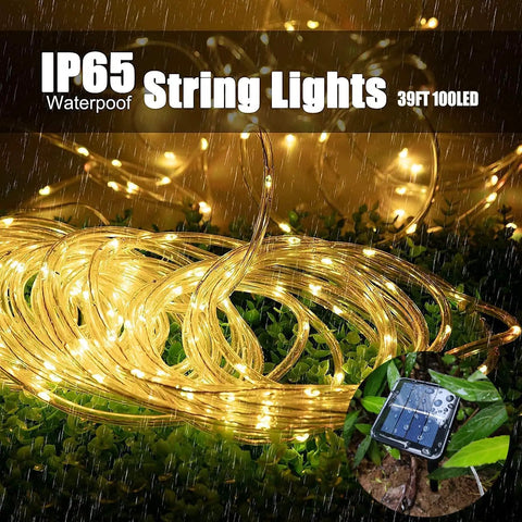 Solar Rope Light IP65 Waterproof 39Ft 100LEDs Outdoor String Lights on grass with solar panel, emitting warm glow