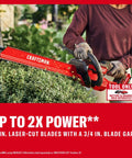 Person using V20 Brushless Cordless Hedge Trimmer 22 Inch With Hedge Sweep Attachment on bushes, laser-cut blades visible