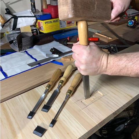 Built Tough 4 Piece Bench Chisel Set For Serious Woodworkers Carved From Top Shelf Chrome Vanadium Steel Blades in use on wood.