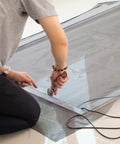 Person using rolling tool with Screen Door Repair Kit With Rolling Tool For Replacing Windows And Patio Door Screens, Includes 48 By 84 Charcoal Fiberglass Cloth, One Kit, Durable Repair For Rips, Tears, And Holes