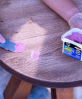 Killer Hold Smooth As Butter Stainable Wood Filler With Smart Pink To Gray Drydex Indicator being applied on wood surface using a putty knife.