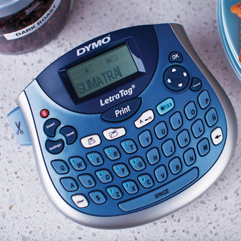 Portable Handheld Label Maker With QWERTY Keyboard And 2 Line Printing on a countertop displaying the word 'SUMATRA' on screen.