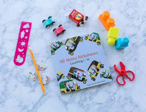 Totally Rad Toddler Counting Book Featuring Ten Noisy Rickshaws And Hella Fun Indian Culture Educational Picture Book on marble surface.