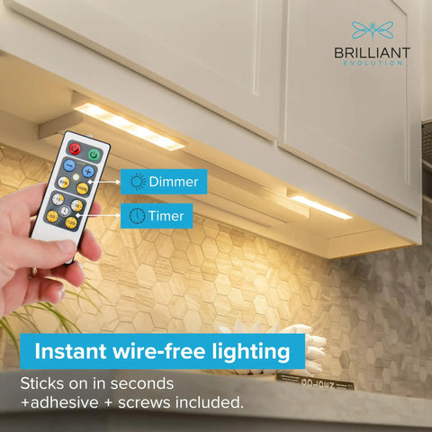 Hand holding remote in front of Ultra Thin 0.6 Inch Under Cabinet Lights 4 Pack With 8.5 Inch Battery Powered LEDs, mounted under kitchen cabinet.
