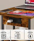 C Shaped Side Table With Charging Station And Wheels For Bedroom Living Room And Home Office Type C USB Ports And Two AC Outlets To Charge Up To Four Devices Plug And Play showcasing charging capabilities with laptop and phone on top.