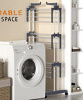 Top Shelf Oversized Four Tier Clothes Drying Rack With A Built Tough Foldable Frame Plus Side Wings For Hanging Laundry Towels Shoes And Quilts Roomy Air Drying Setup next to a washing machine in a compact laundry space.