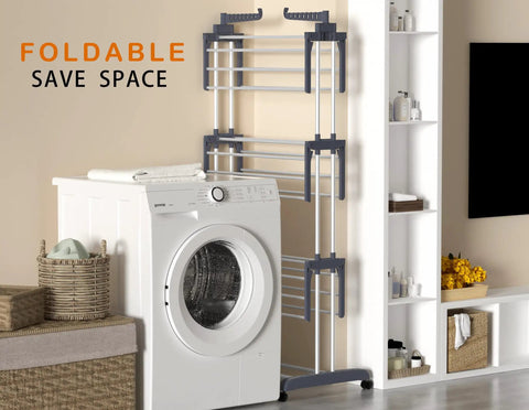 Top Shelf Oversized Four Tier Clothes Drying Rack With A Built Tough Foldable Frame Plus Side Wings For Hanging Laundry Towels Shoes And Quilts Roomy Air Drying Setup next to a washing machine in a compact laundry space.