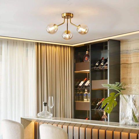 Three Light Sputnik Chandelier In Bold Gold Finish Semi Flush Mount Ceiling Light Fixture With Glass Globe in modern room