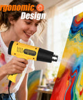 Woman using 1300W Heat Gun With Adjustable Temperature And Overload Protection, Dual Gear Button Control, Yellow Nozzles on painting