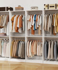 Big Time Modular Closet System With Hella Roomy Hanging Space And Solid Wood Build For Custom Walk In Setup showing white storage towers with clothes.