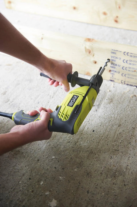 Compact Hammer Drill With Variable Speed Trigger And Reversal Built Lightweight Yet Punchy For Concrete Tasks With One Hand Quick Release Chuck And Rubberized Comfort Grip For All Day Diy Hustle Smooth Home Repair being used to drill into wood.
