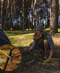 Rugged Heavy Duty 8 Inch Steel Tent Stakes For Camping Rock Solid Pegs Eight Pack with user securing tent in forest