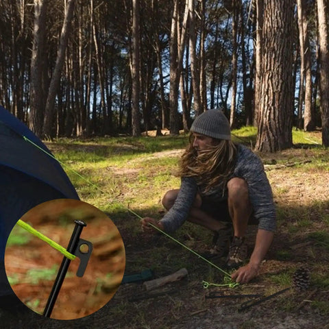 Rugged Heavy Duty 8 Inch Steel Tent Stakes For Camping Rock Solid Pegs Eight Pack with user securing tent in forest