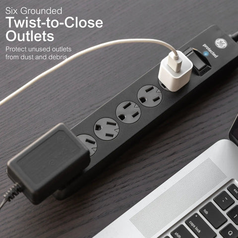 Six Outlet Surge Protector With Ten Foot Extension Cord For A Simple No Fuss Power Strip Setup And 800 Joules Of Surge Protection Twist To Close Safety Covers Protected Indicator Light ETL Listed Black shown on a table with a laptop.