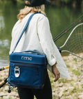 Woman carrying 15 Can Everyday Soft Sided Go To Cooler for Lunch Beach Travel and Camping Insulated Portable Cooler for Men and Women Navy