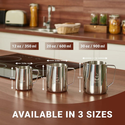 Three stainless steel milk frothing pitchers in sizes 12oz, 20oz, 30oz on a kitchen counter with size labels