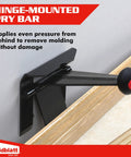 Hinge-mounted pry bar applying pressure to remove molding without damage, shown in a side view with ergonomic handle.