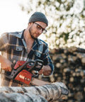 Man wearing 10 Pack Slip On Eye Glasses Side Shields For Safety Glasses, Flexible TPU Protective Shields, using chainsaw outdoors