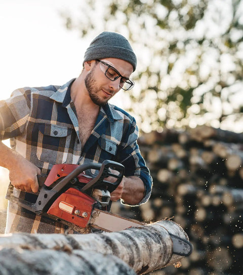 Man wearing 10 Pack Slip On Eye Glasses Side Shields For Safety Glasses, Flexible TPU Protective Shields, using chainsaw outdoors