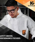 Man wearing Unisex Maverick Safety Glasses with Anti Fog Coating and Smoke Lenses, black frame, polycarbonate lenses, in lab.