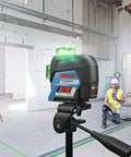 Boss Class 12V Max Three Plane Green Beam Laser Level in use with contractors in a construction site setting.