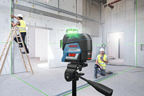 Boss Class 12V Max Three Plane Green Beam Laser Level in use with contractors in a construction site setting.